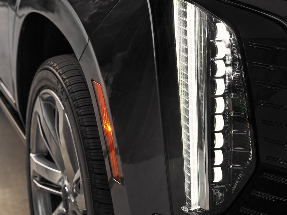  Detail shot of Escalade's vertical daytime running lights and hood contours