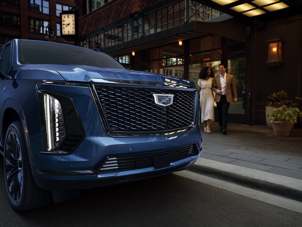  Close-up of Escalade's illuminated Cadillac crest and chrome mesh grille