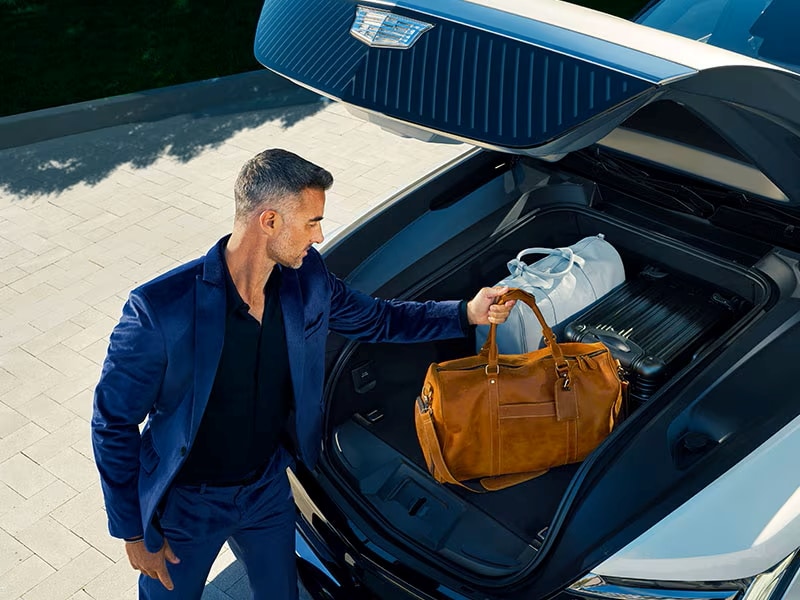 A Man Placing His Bags in the 2026 Cadillac ESCALADE IQL eTrunk