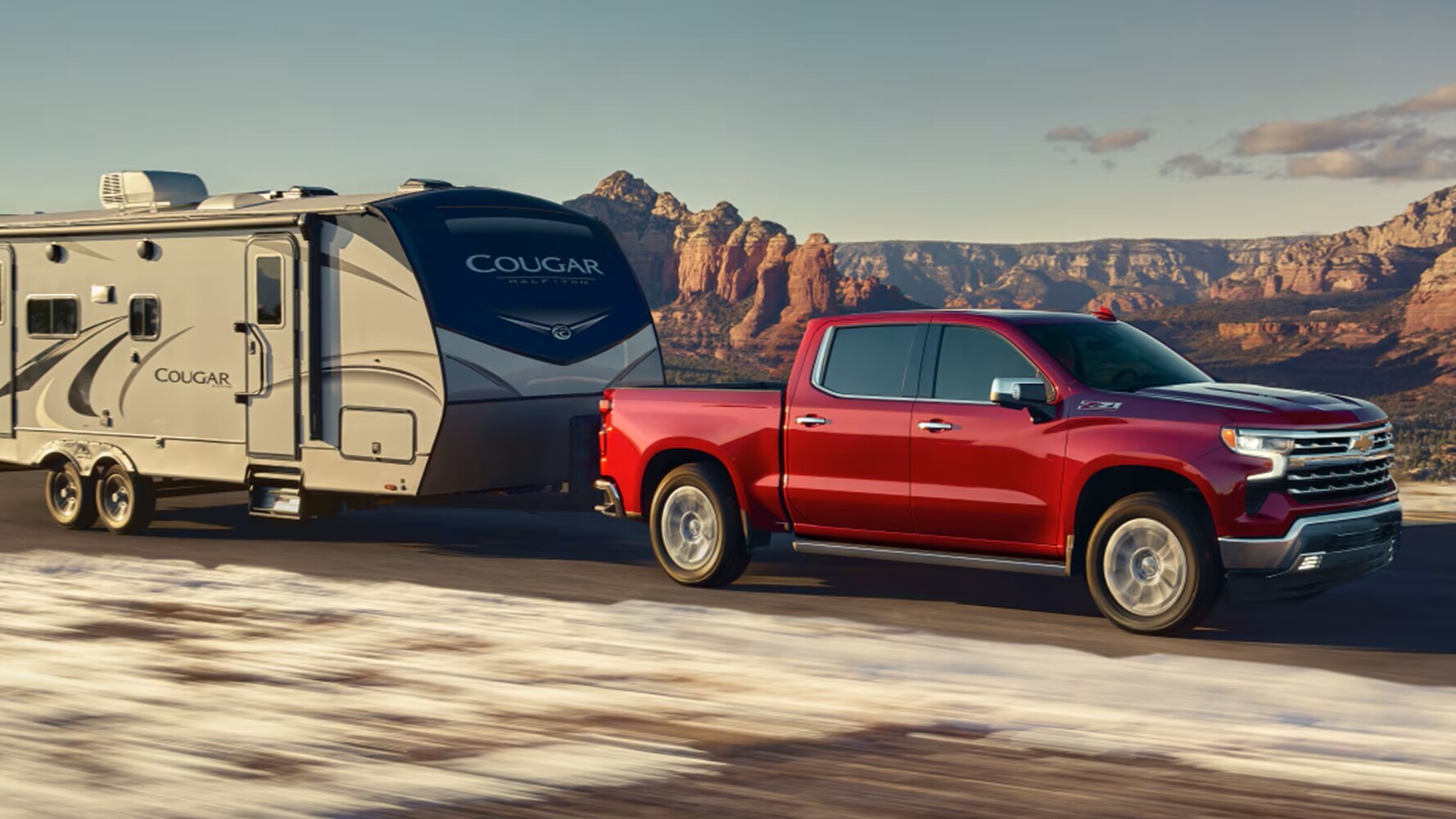 2026 Silverado LTZ shown in Radiant Red Tintcoat towing camper