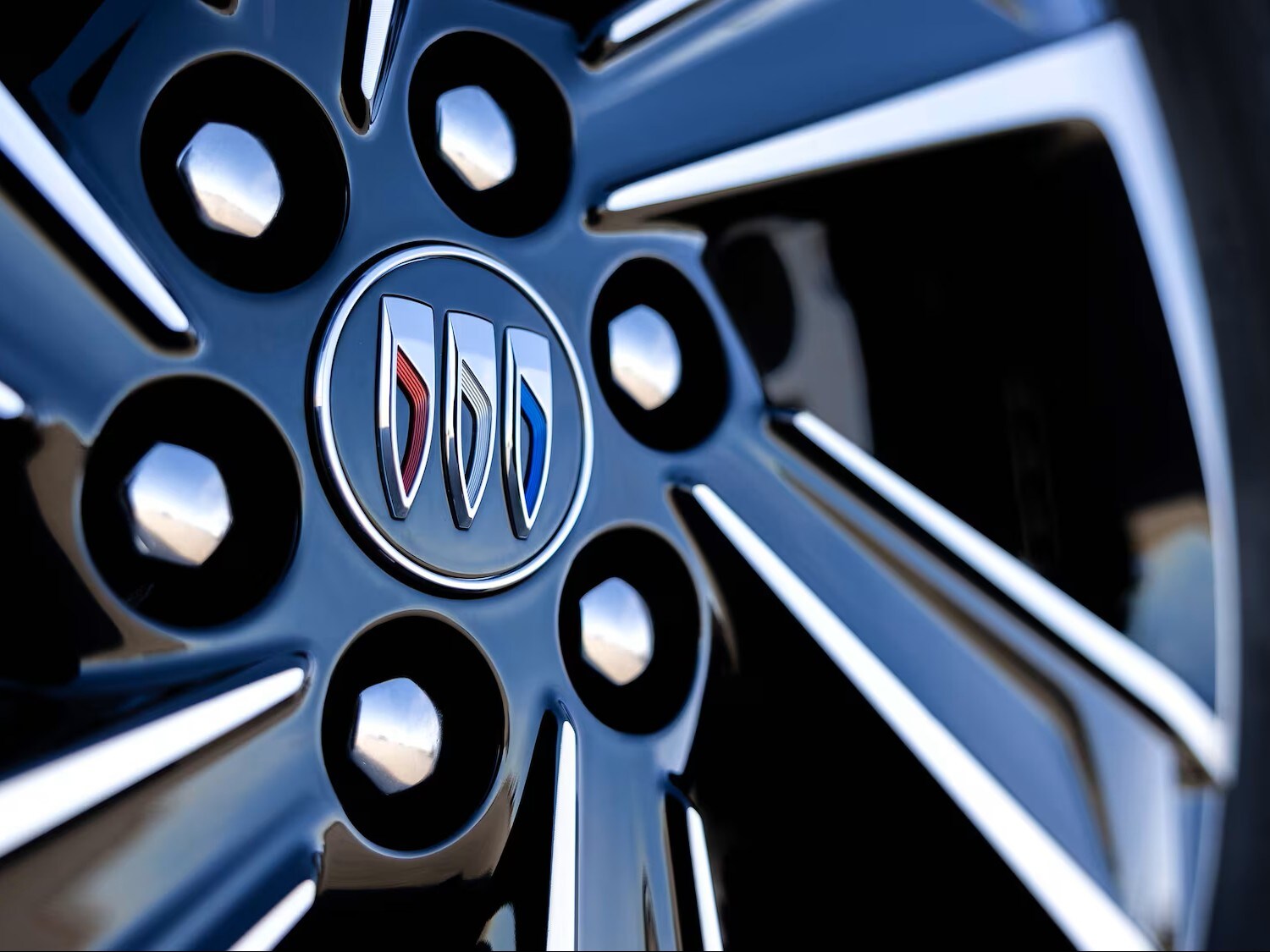 Close-up of a 2026 Buick Enclave Tire Focusing and Buick Emblem