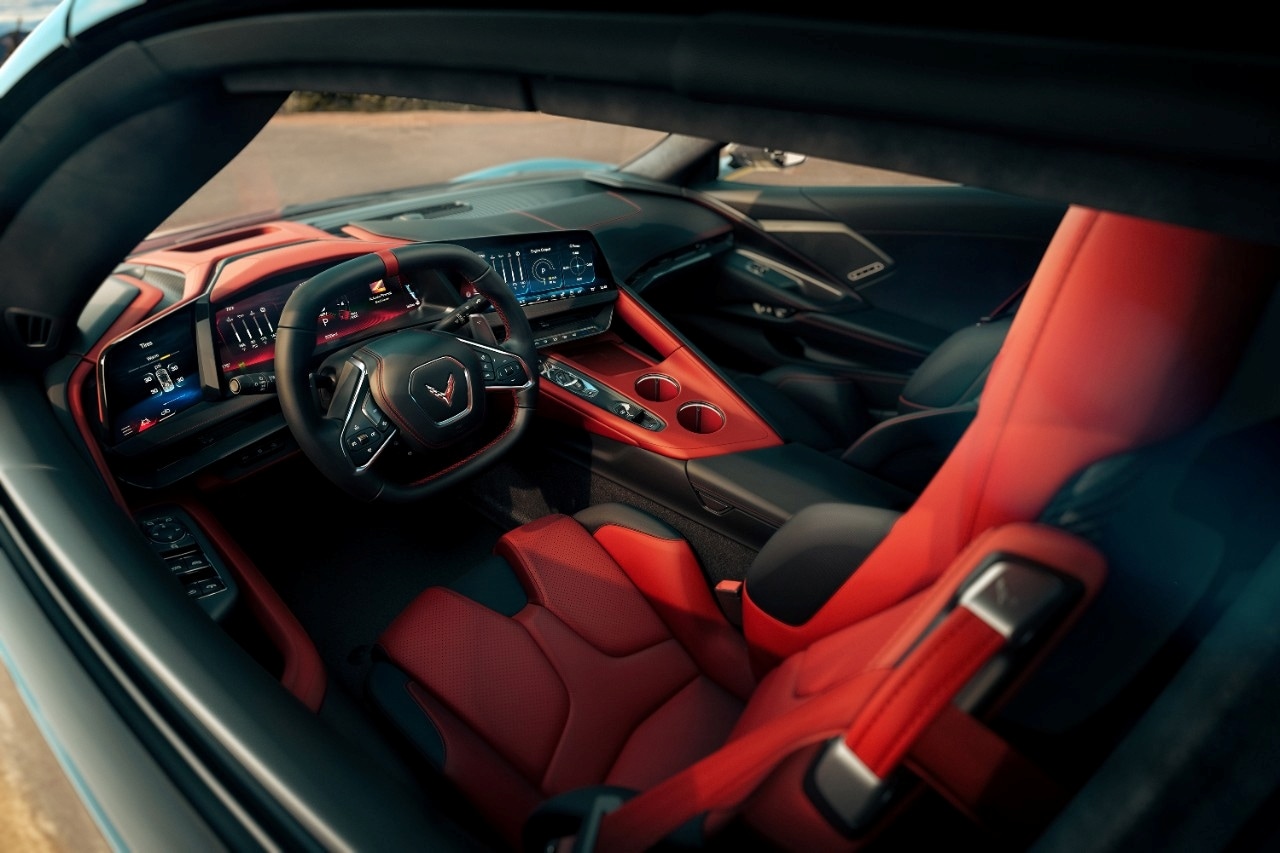 2026 Corvette ZR1X cockpit with triple-screen layout and Adrenaline Red Napa leather