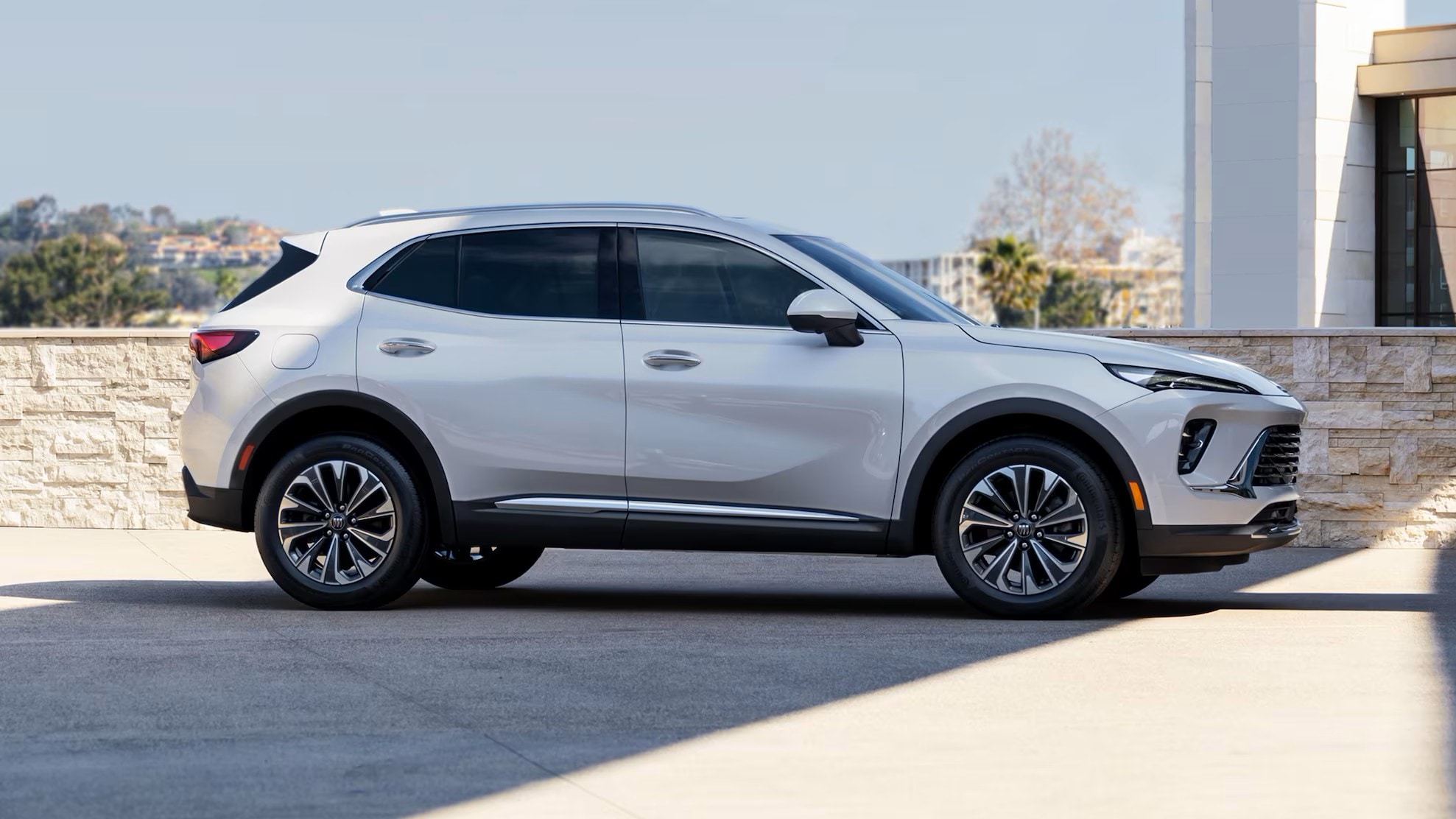  Side profile of 2025 Envision in Summit White with 20-inch Carbon Flash wheels