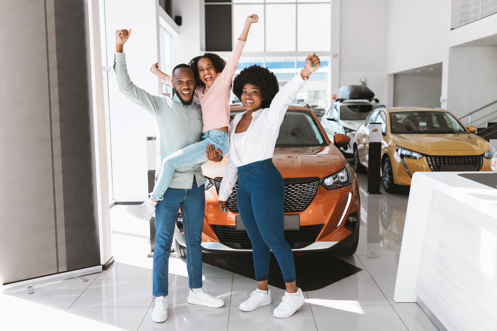 Family of Three Celebrating the Purchase of a Used Car near Redford MI
