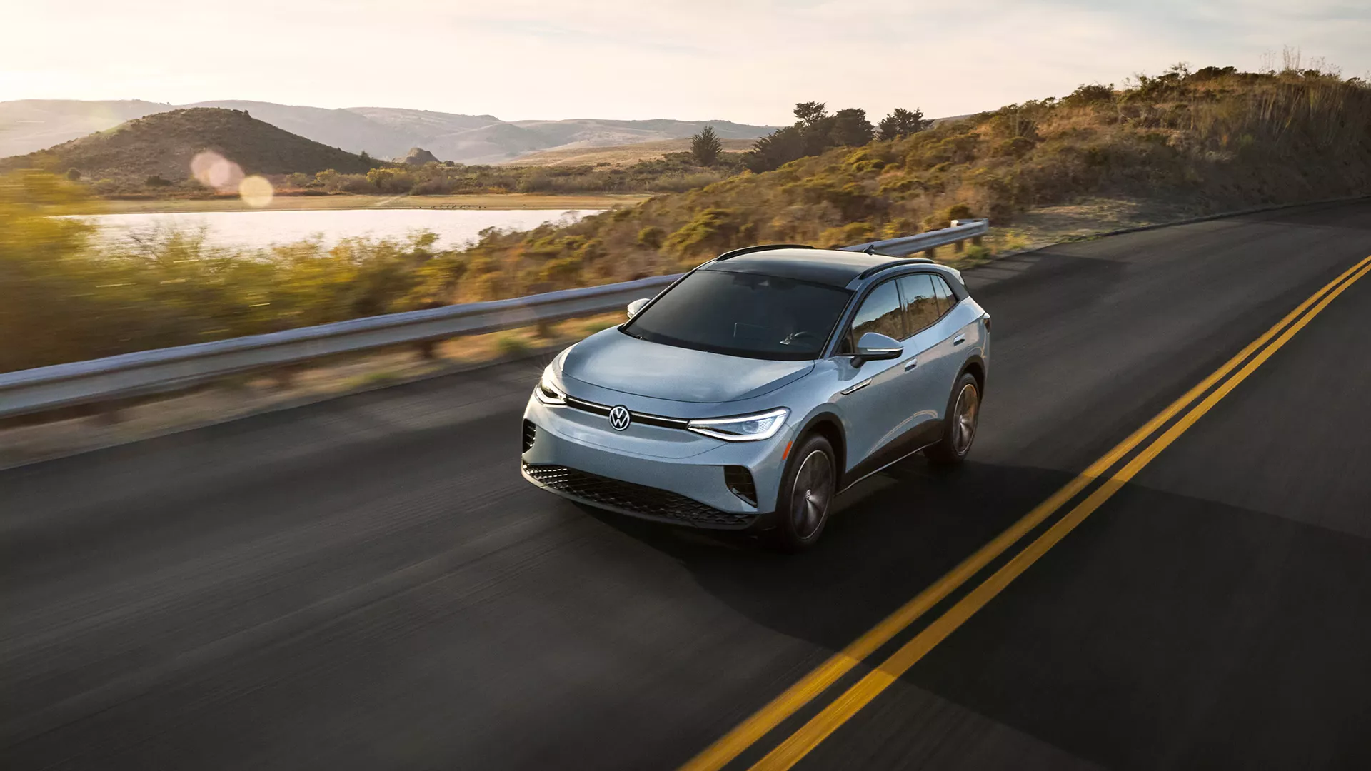 A quickly accelerating Atreon shown in Kingfisher Blue Metallic blurs the shoulder and roadside vegetation around it.