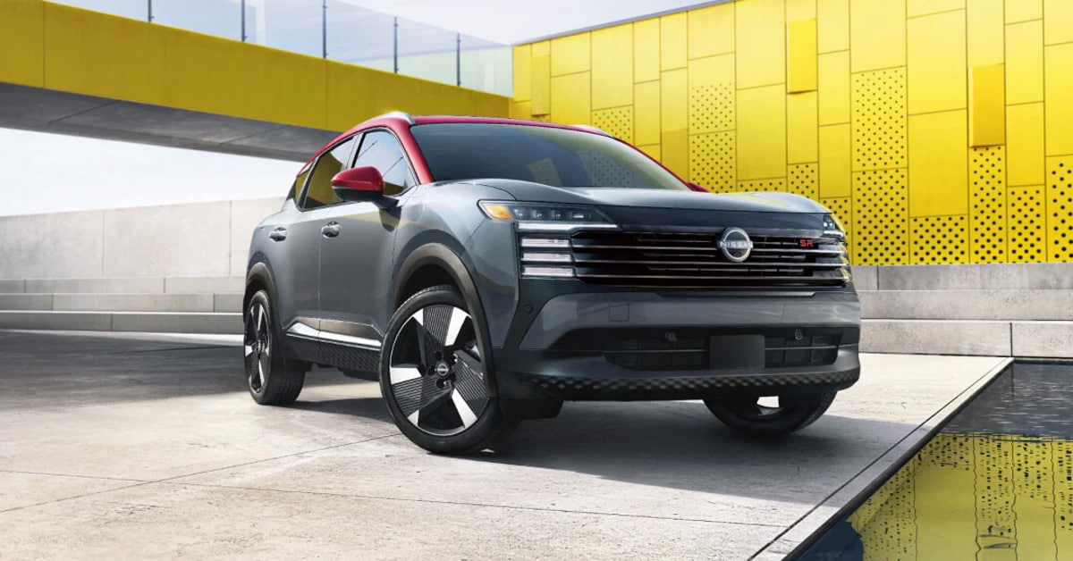 2026 Nissan Kicks SR - Parked outdoors in front of a modern yellow building