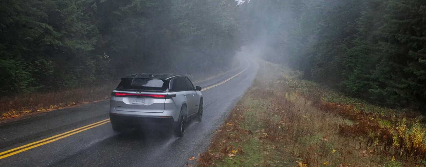 Silver 2024 Jeep Wagoneer S driving through fog