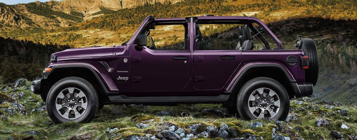 Purple 2023 Jeep Wrangler Sahara Unlimited parked off road