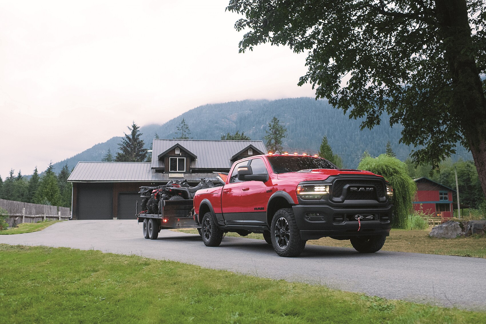 Ram 1500 Hybrid Truck with trailer parked in front of house