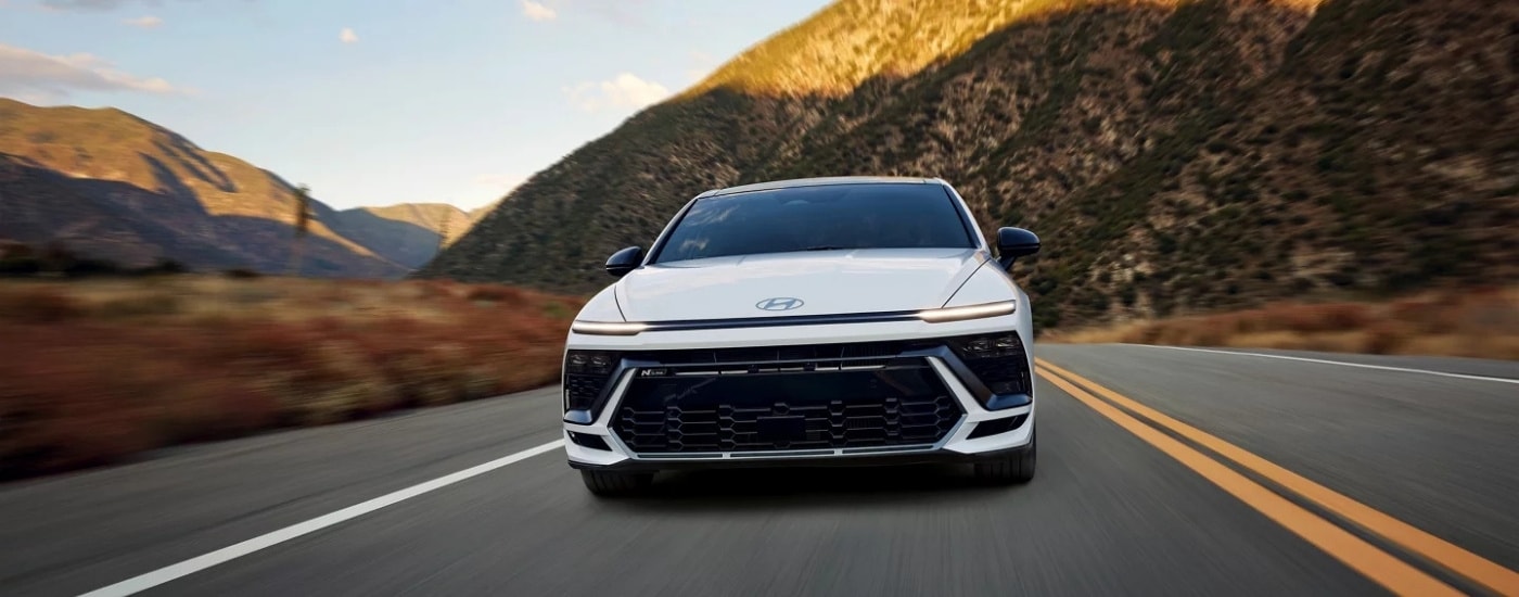 White 2025 Hyundai Sonata N driving through canyons
