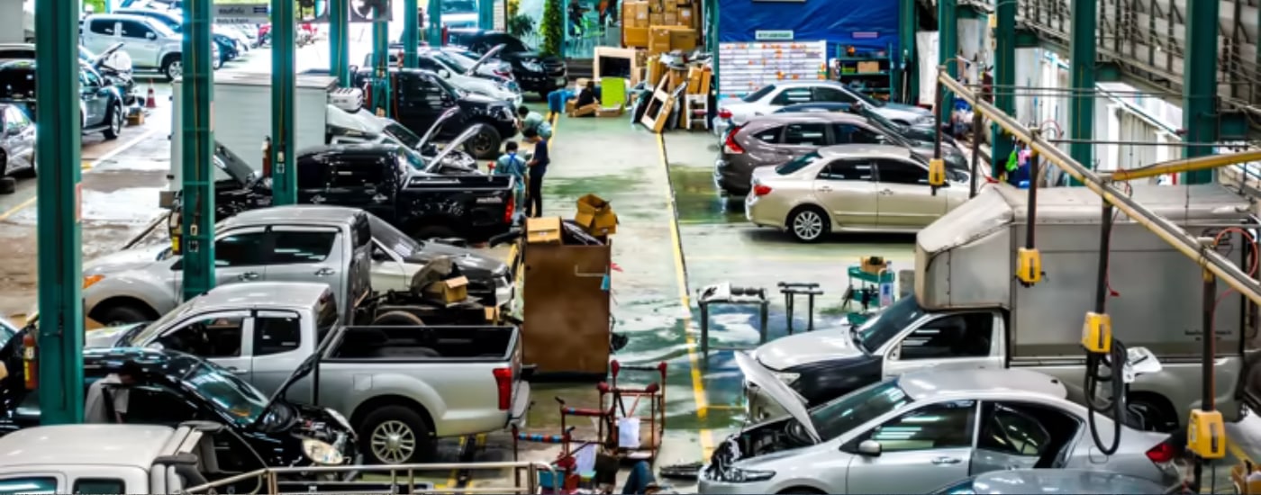 The floor of a service center filled with vehicles being worked on