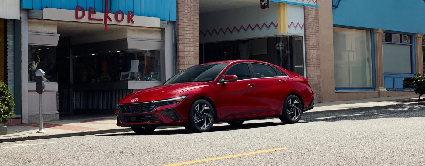 Red 2026 Hyundai Elantra parked near a Hyundai dealer