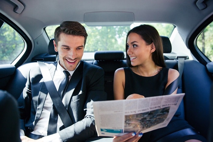 Couple_Reading_Newspaper_In_Car.jpg