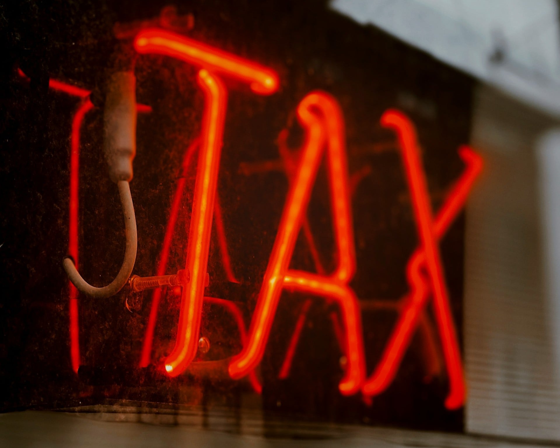 neon sign that says TAX