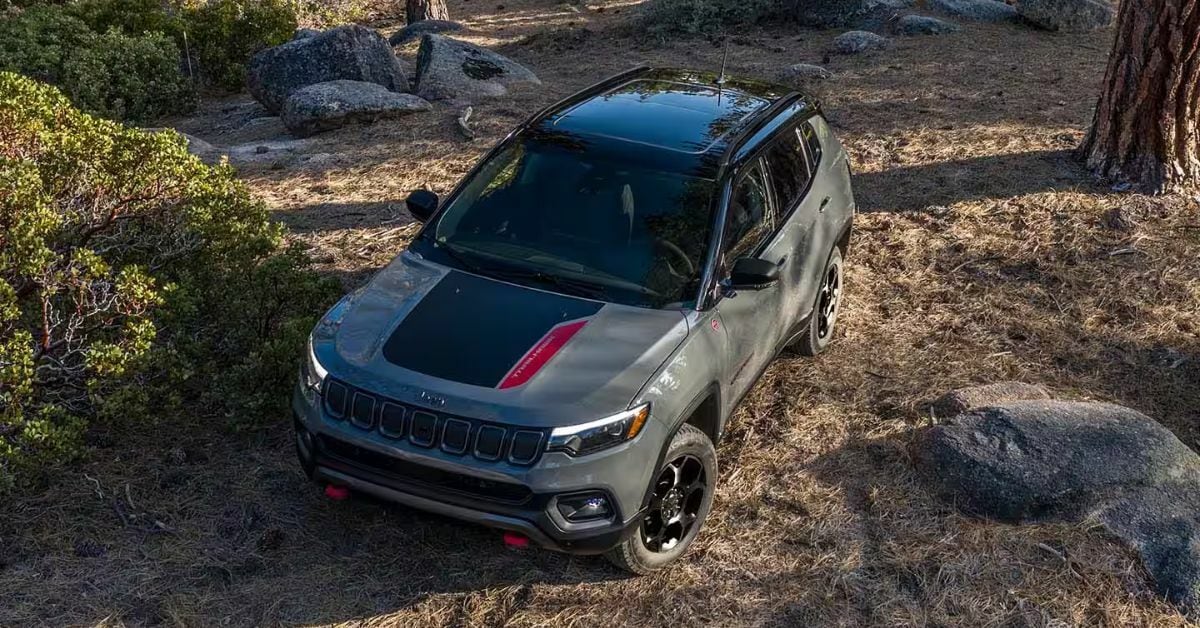 Gray 2024 Jeep Compass Parked in the Forest | Sierra Blanca Motors