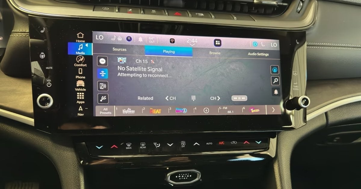  A close-up view of a 2026 Jeep Grand Cherokee's infotainment system, featuring a large touchscreen display with a sidebar for navigation options like Media, Comfort, and Phone. The screen shows a satellite radio interface with a 