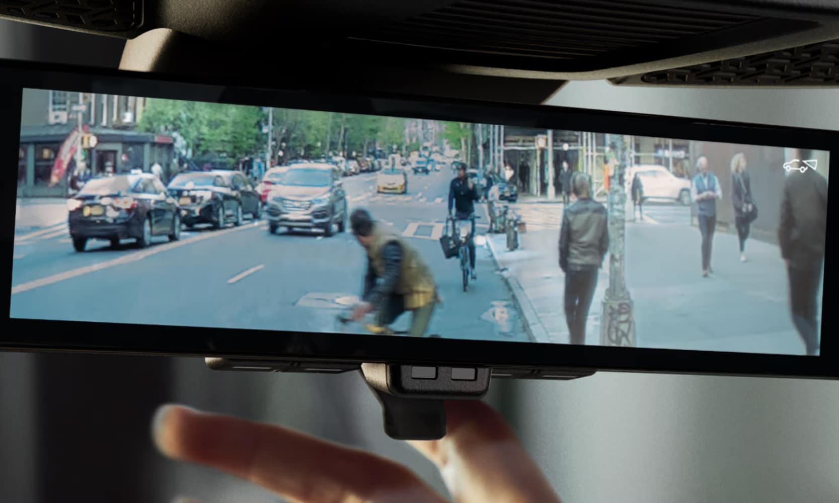 2026%20Nissan%20ARIYA%20Safety%20Ratings%20%20Nissan%20of%20Silsbee%20TX.png Closeup image of the 2026 Nissan ARIYA rear-view mirror showing cars and pedestrians