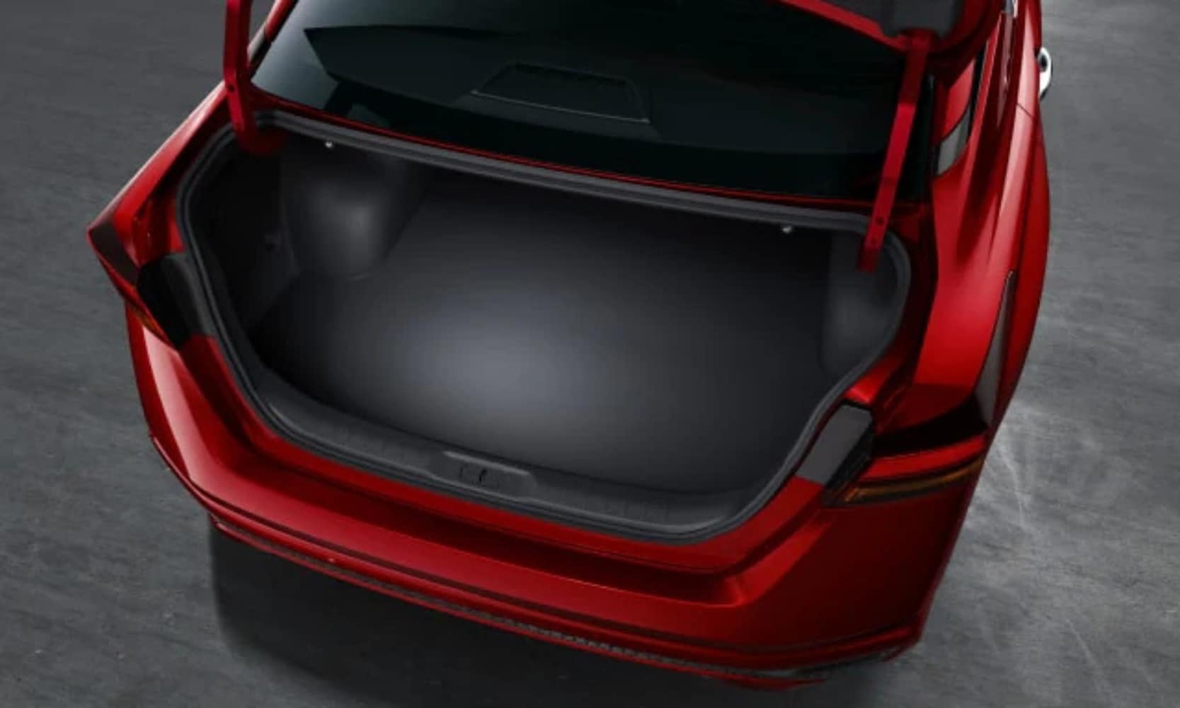 Exterior image of a red 2025 Nissan Altima open empty trunk