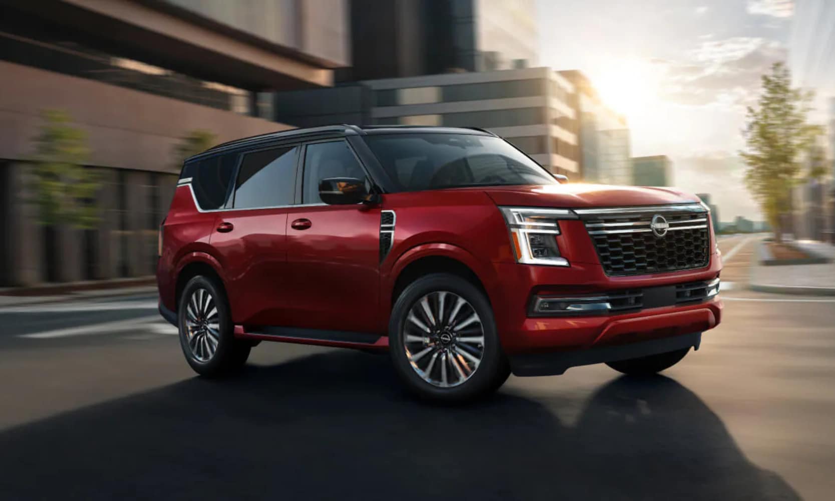 Exterior front image of a red 2025 Nissan Armada turning on a city street