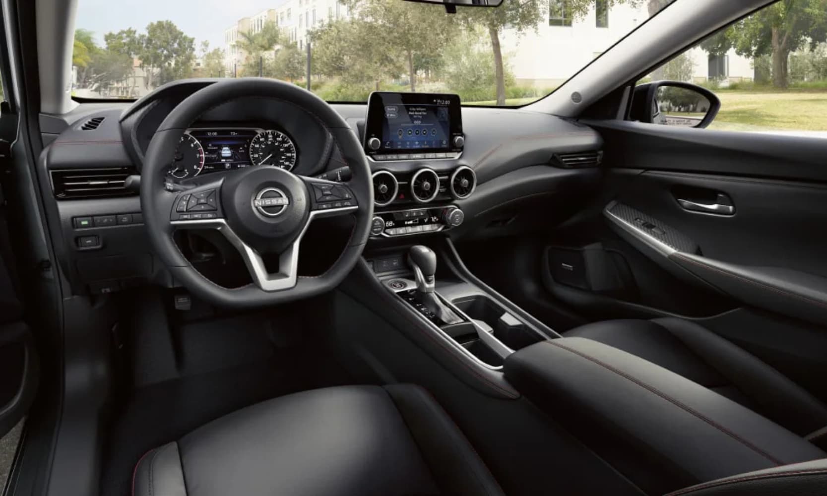 Interior image of a 2025 Nissan Sentra front seating area and dashboard on a residential street during the day