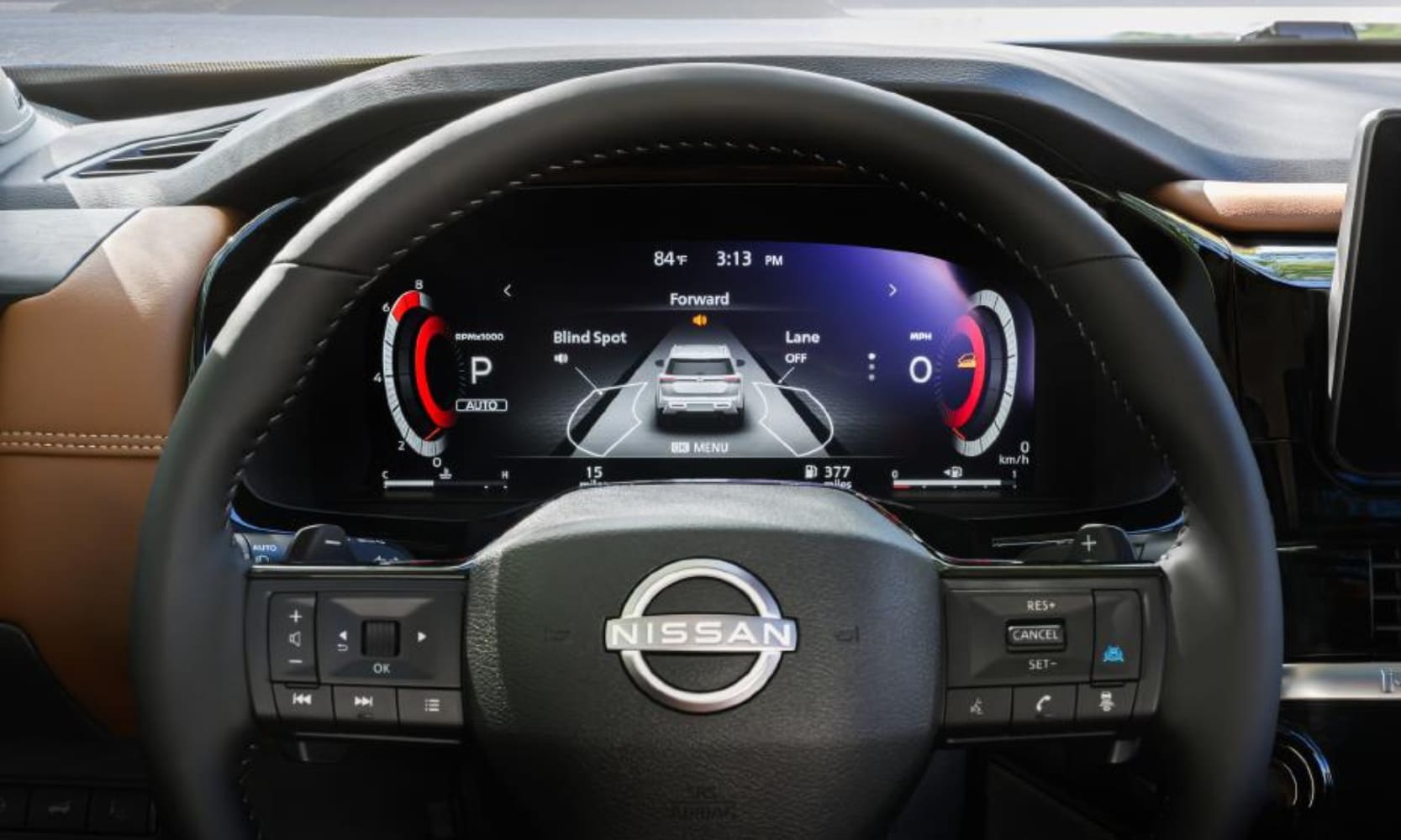 Closeup image of the 2026 Nissan Pathfinder steering wheel and safety features on the dashboard behind it