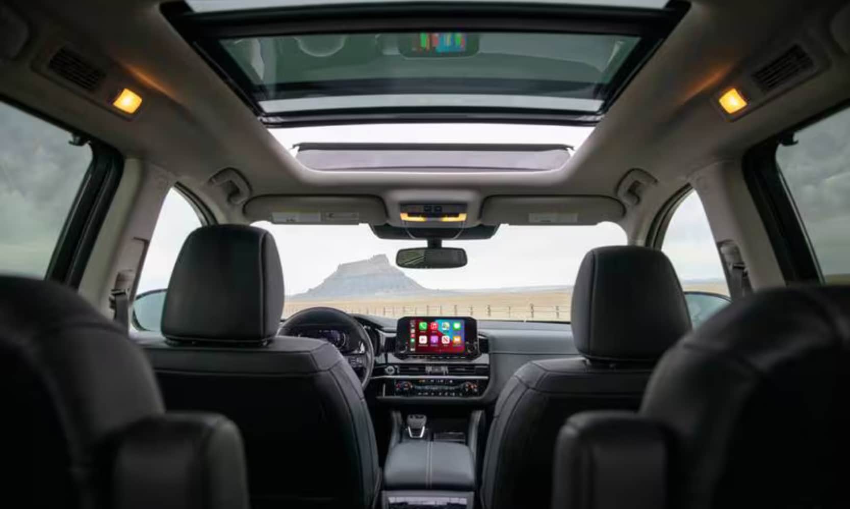 Interior image of a 2023 Nissan Pathfinder Platinum with views of the front and middle rows from the third row