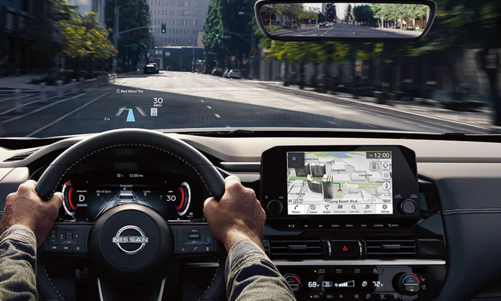 Interior image of a 2025 Nissan Pathfinder infotainment system and Head-Up Display while driving on a city street