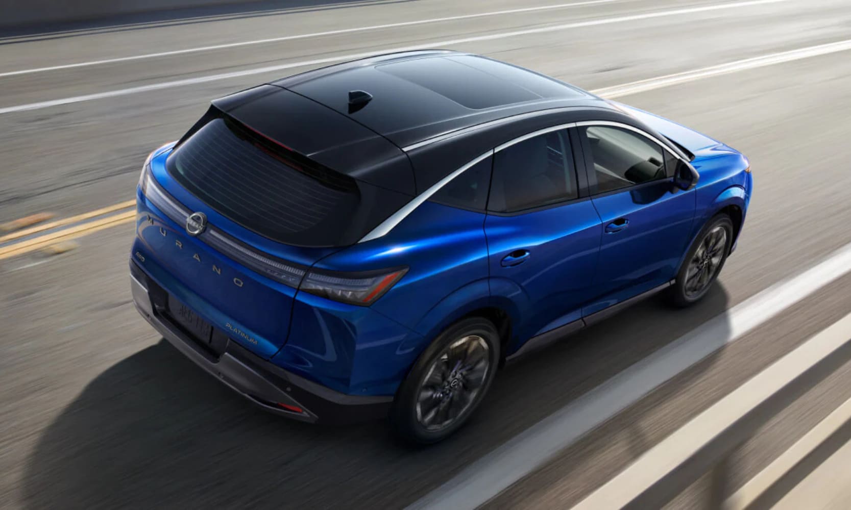 Exterior rear-view image of a blue 2025 Nissan Murano Platinum driving on a freeway