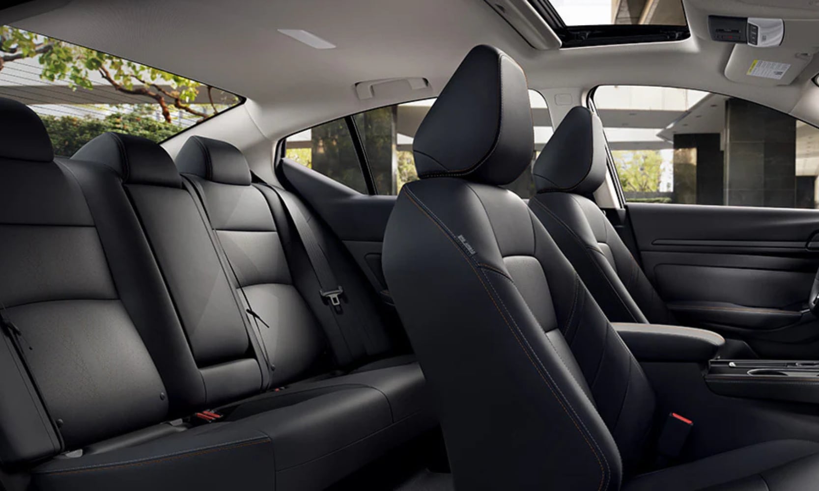 Closeup interior image of a 2025 Nissan Altima two seating rows and open sunroof