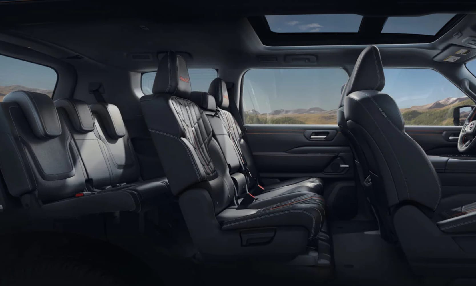 Interior side image of the 2025 Nissan Armada dark gray three-row seats