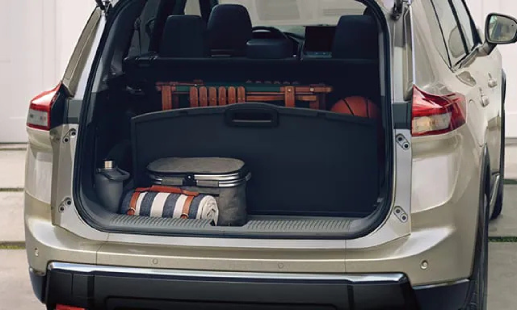 Exterior rear-view image of a 2026.5 Nissan Rogue opened with items stored inside