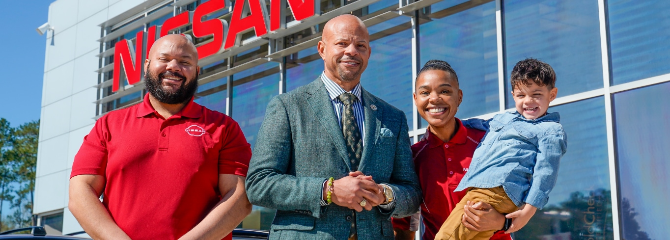 Silsbee Nissan team standing in front of the dealership