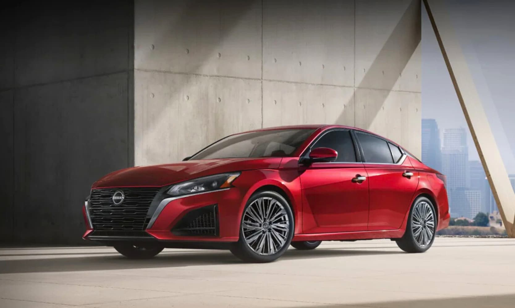 Exterior side image of a red 2026 Nissan Altima parked on an elevated building in a cityscape environment