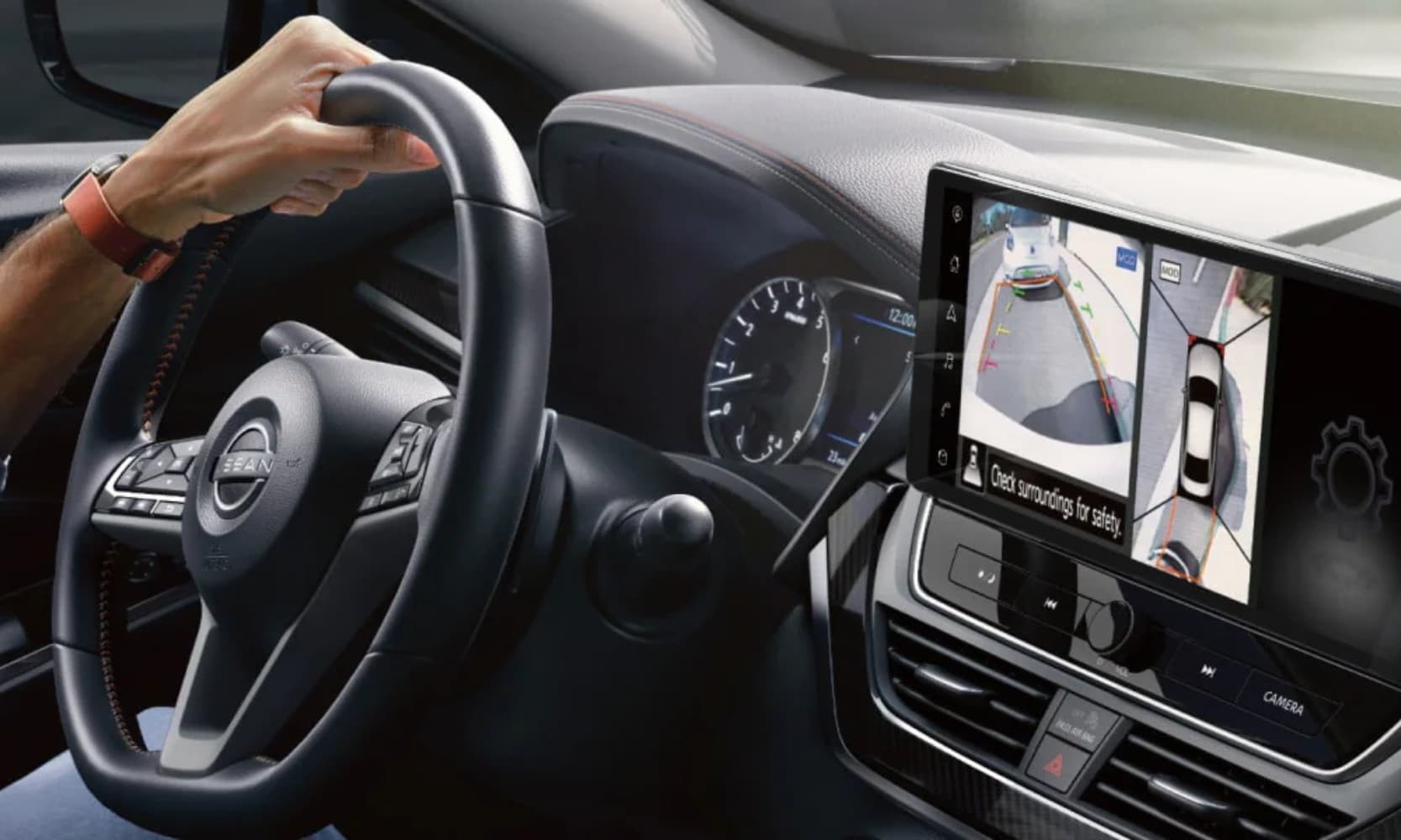 Closeup interior image of a driver using the Intelligent Around View Monitor in a 2025 Nissan Altima