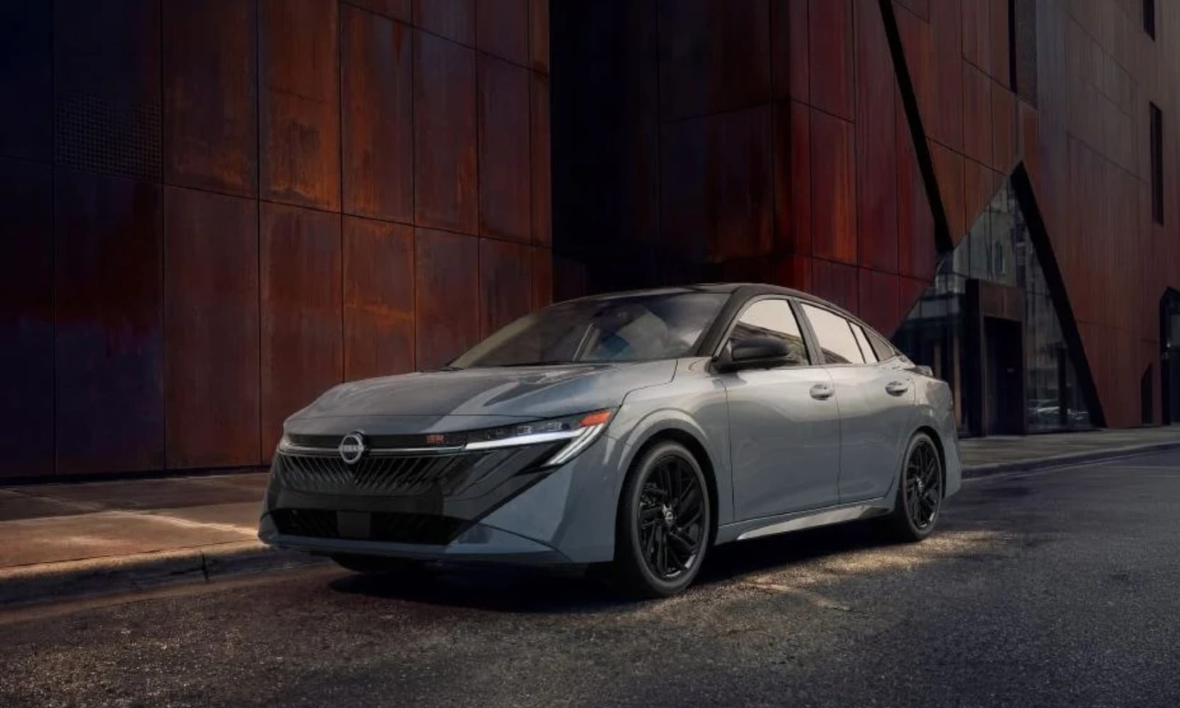 Exterior image of a gray 2027 Nissan Sentra SR Midnight Edition parked on a street outside a building