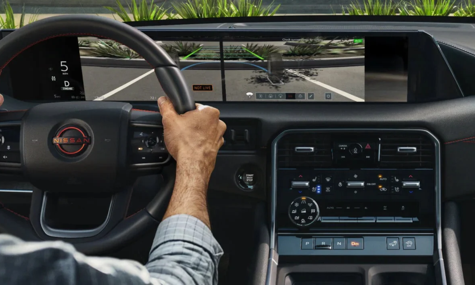 Image of a driver inside a 2027 Nissan Armada using the Invisible Hood View safety feature