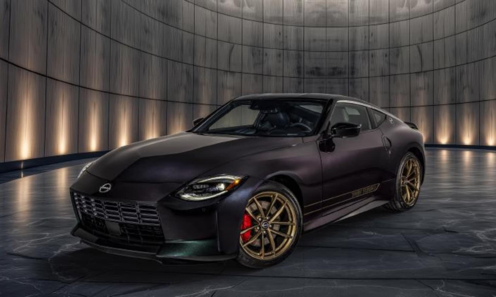 Exterior front angle image of a black 2026 Nissan Z Heritage Edition parked in an illuminated showroom