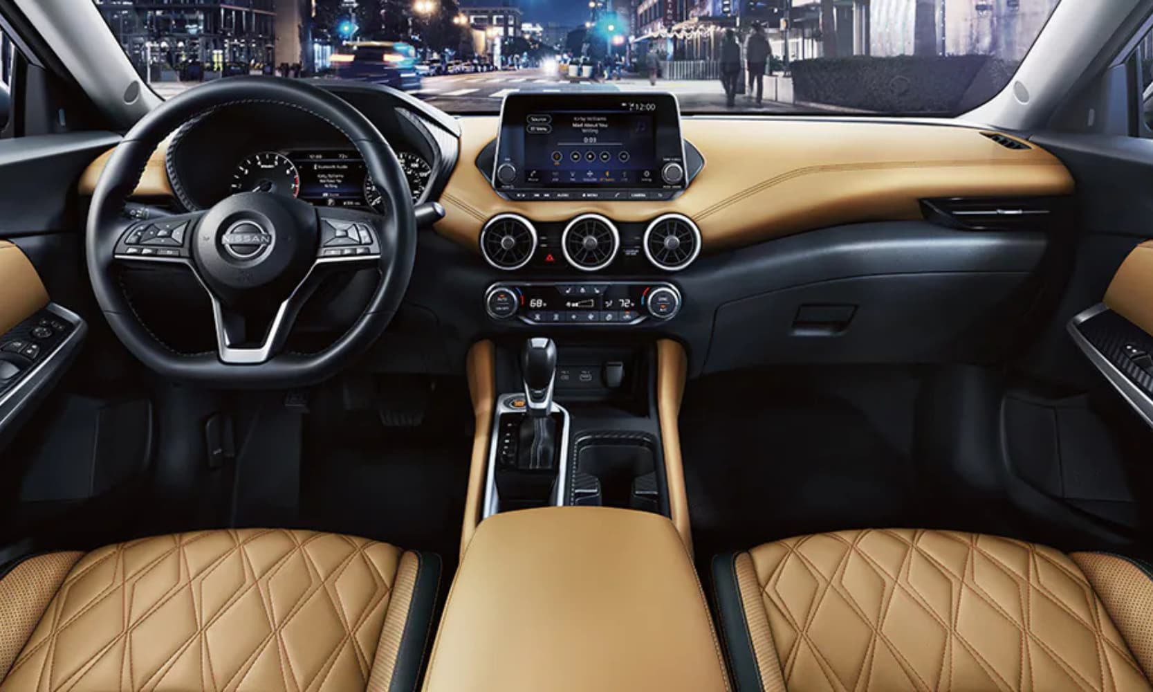 Interior front row image of the 2025 Nissan Sentra with cityscape views at night and tan and black leather seating