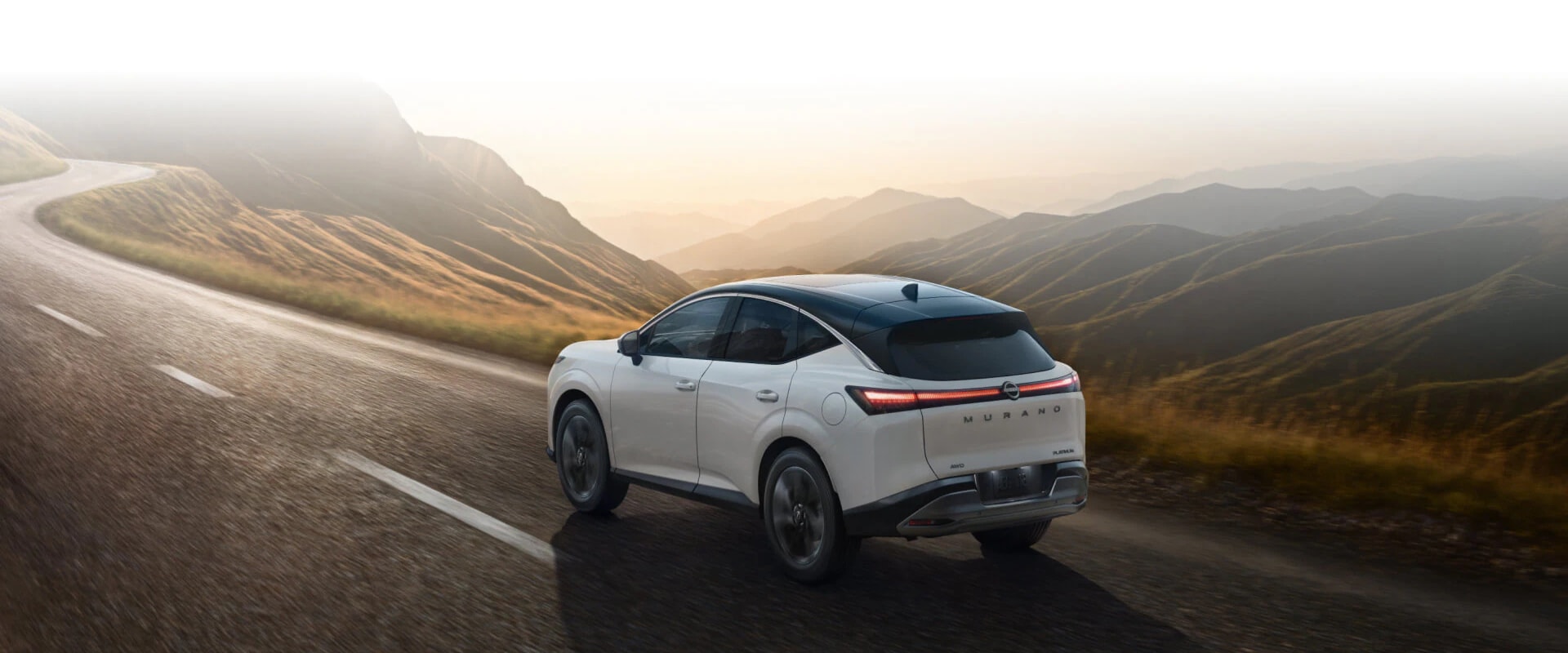 Exterior image of a light green 2025 Nissan Armada driving up a dirt hill in a mountainous setting