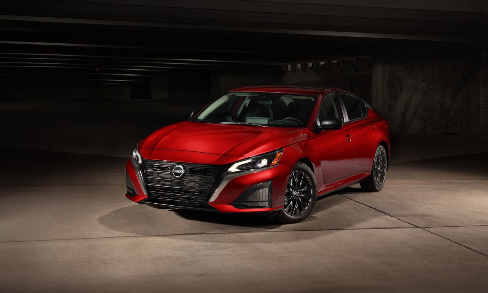 Exterior front image of a red 2026 Nissan Altima SV Special Edition parked in a dark parking garage