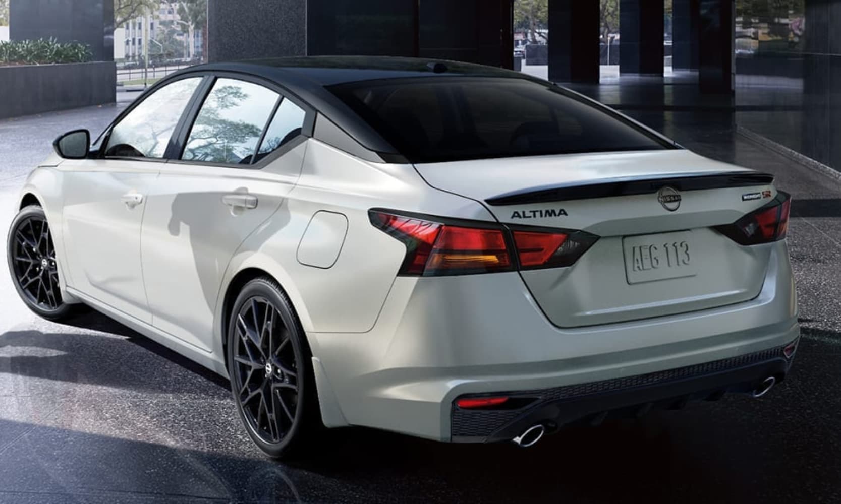 Exterior rear-view image of a white 2026 Nissan Altima SR Midnight Edition parked in a building