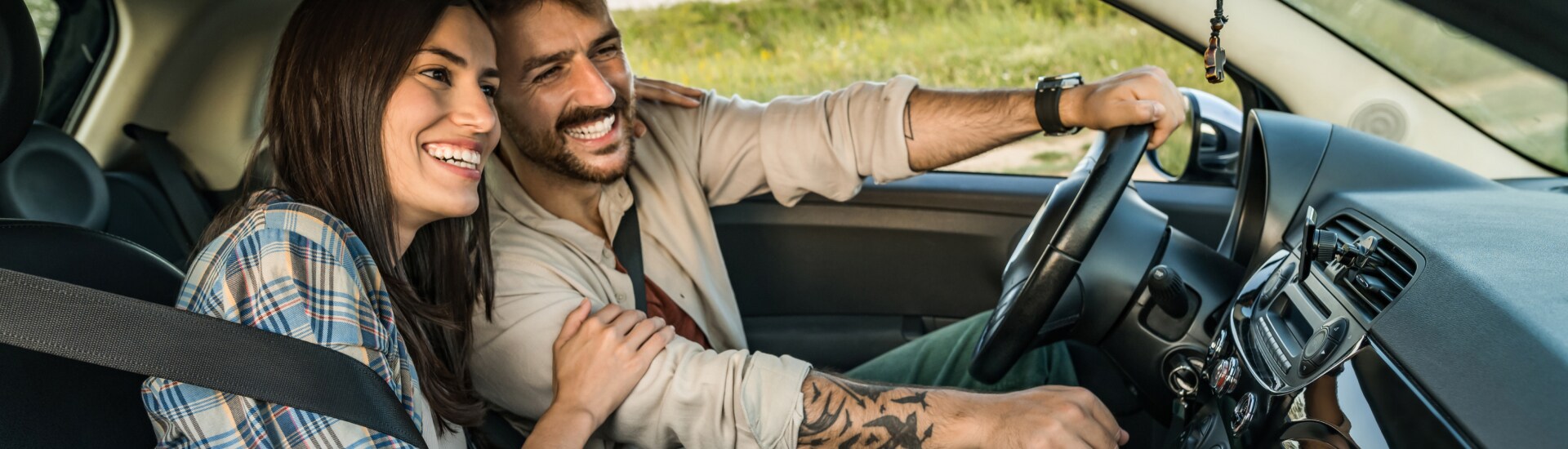 A couple driving their new car