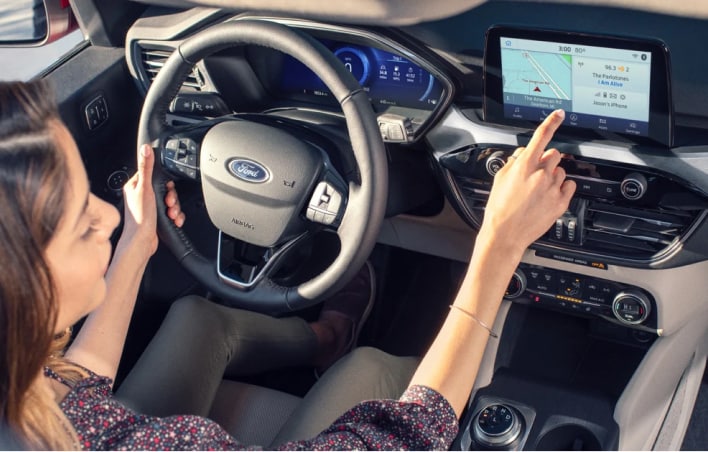Woman using the cars infotainment system