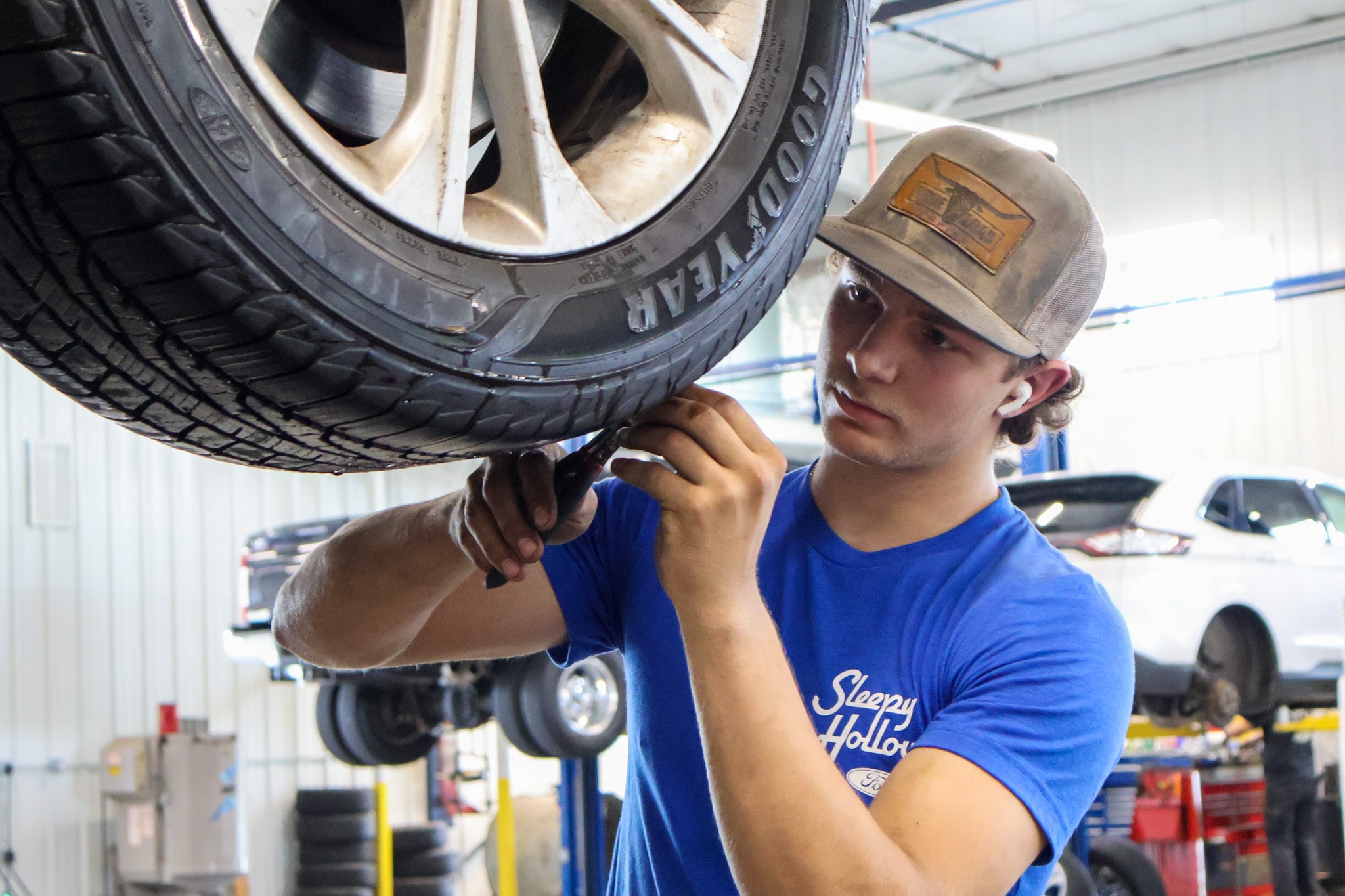 Ford technician measuring tire tread depth