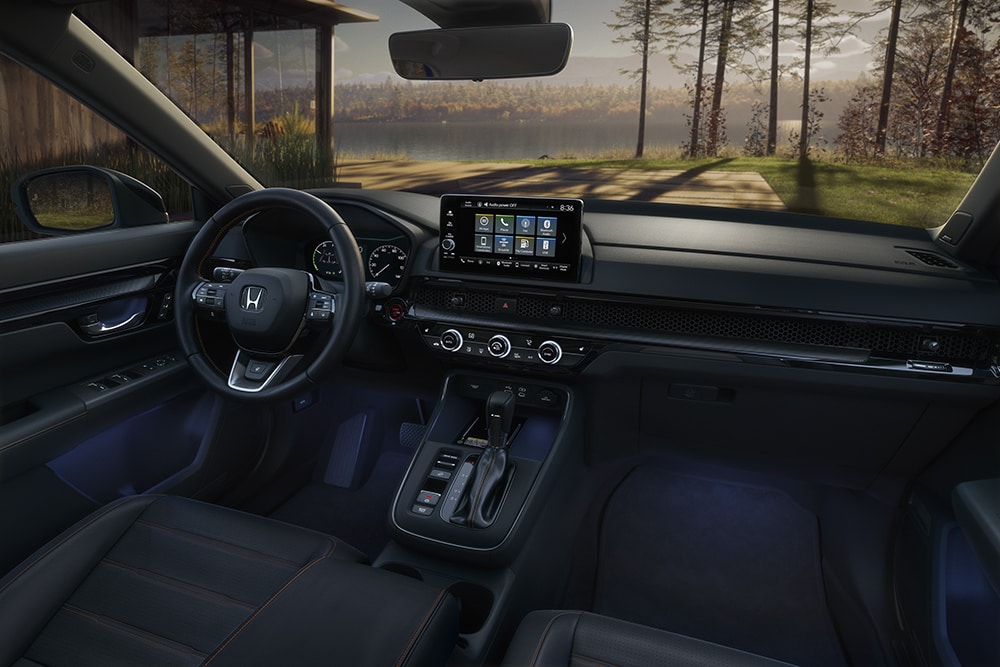 Steering wheel with interior of front seats and infotainment touchscreen in the Honda CR-V.