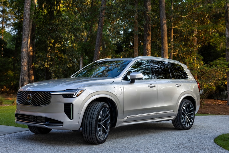 Silver Volvo XC90 parked among trees