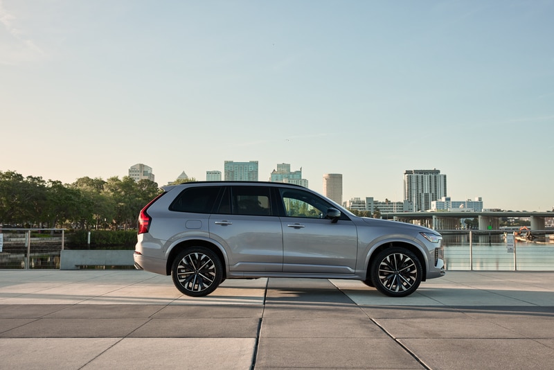 Side profile of a silver Volvo XC90 in an urban waterfront setting