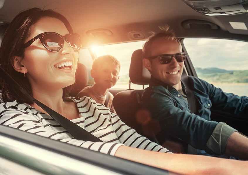 Happy family driving in their new car