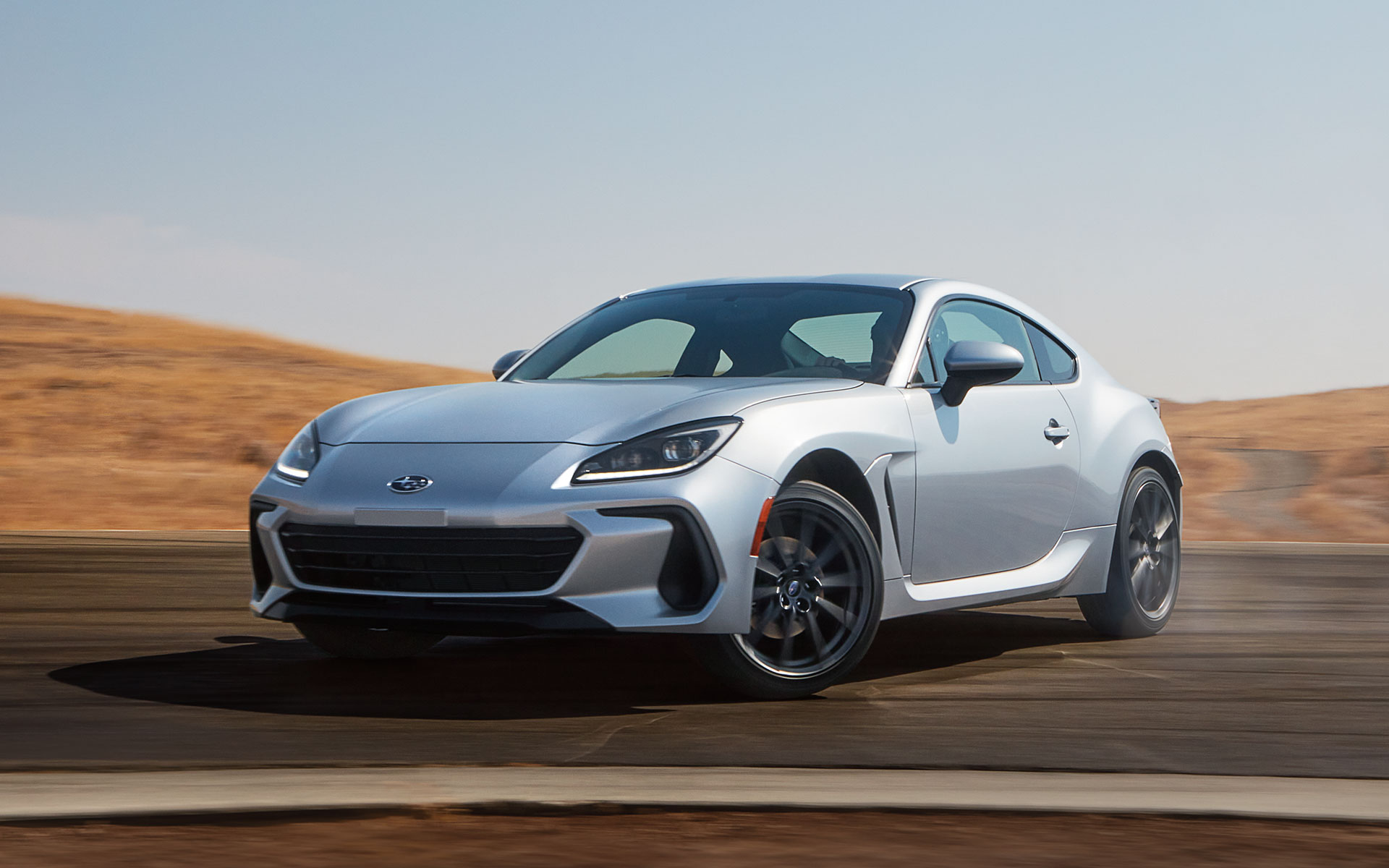 2022 Subaru BRZ Limited shown in Ice Silver Metallic rounding a curve on a highway.