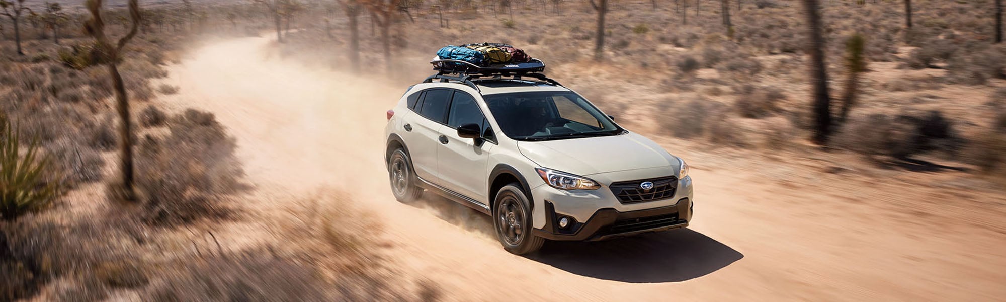 A 2023 Crosstrek driving in a desert